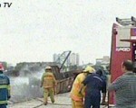 Los bomberos apagan el fuego que incendió al buque.