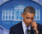 US President Barack Obama wipes a tear from his eye as he speaks during a previously unannounced appearance in the Brady Briefing Room of the White House on December 14, 2012 in Washington, DC. Obama spoke following the shooting in a Connecticut Elementary School which left at least 27 people dead. President Obama on Friday ordered US flags on the White House, official buildings and at military facilities to half staff to honor the victims of the school shooting rampage in Connecticut. The order remains in effect until sunset on December 18, the president said in a proclamation, decrying the attack as a "senseless acts of violence" moments before giving his first on camera reaction to the tragedy.   AFP PHOTO/Mandel NGAN
 US-CRIME-SHOOTING-POLITICS-OBAMA