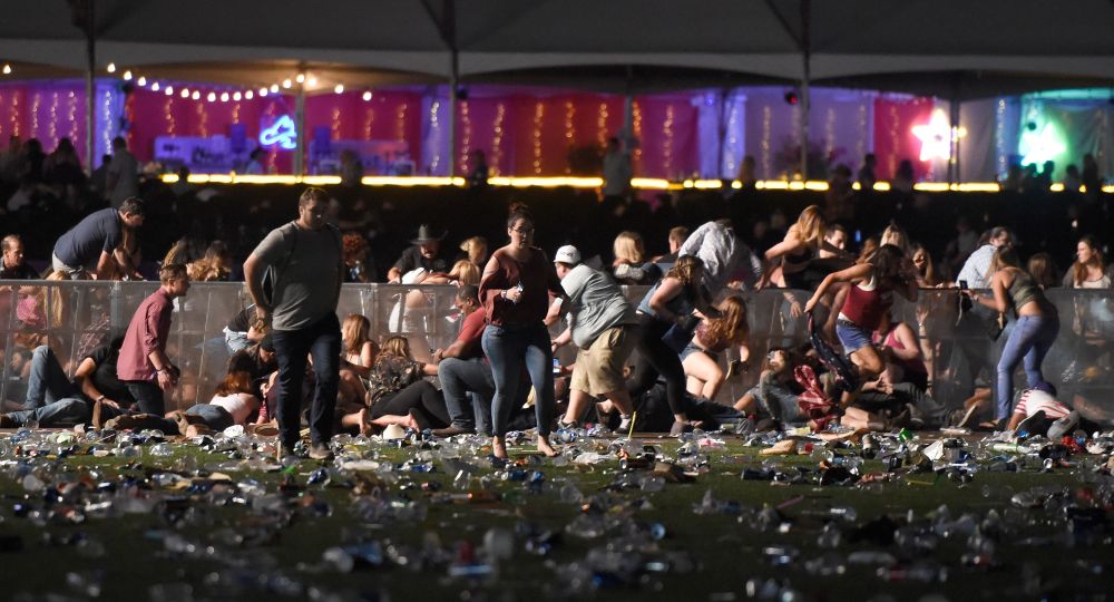 LAS VEGAS, NV - OCTOBER 01 People run from the Route 91 Harvest country music festival after apparent gun fire was heard on October 1, 2017 in Las Vegas, Nevada. There are reports of an active shooter around the Mandalay Bay Resort and Casino.   David Becker/Getty Images/AFP