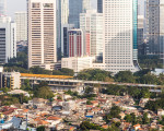 Middle to low class residential district contrasts with the modern skyscrapers of the business district of Jakarta in Indonesia capital city.